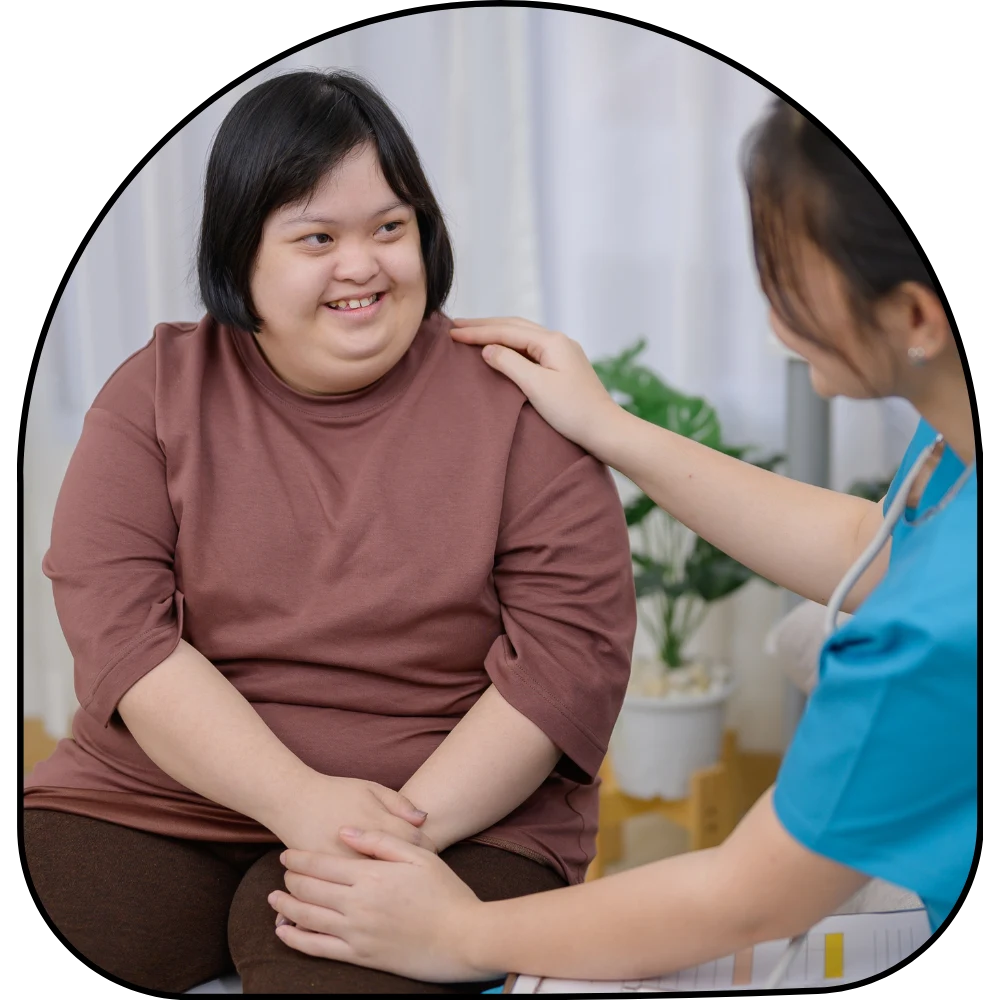 Disabled woman at home with nurse smiling